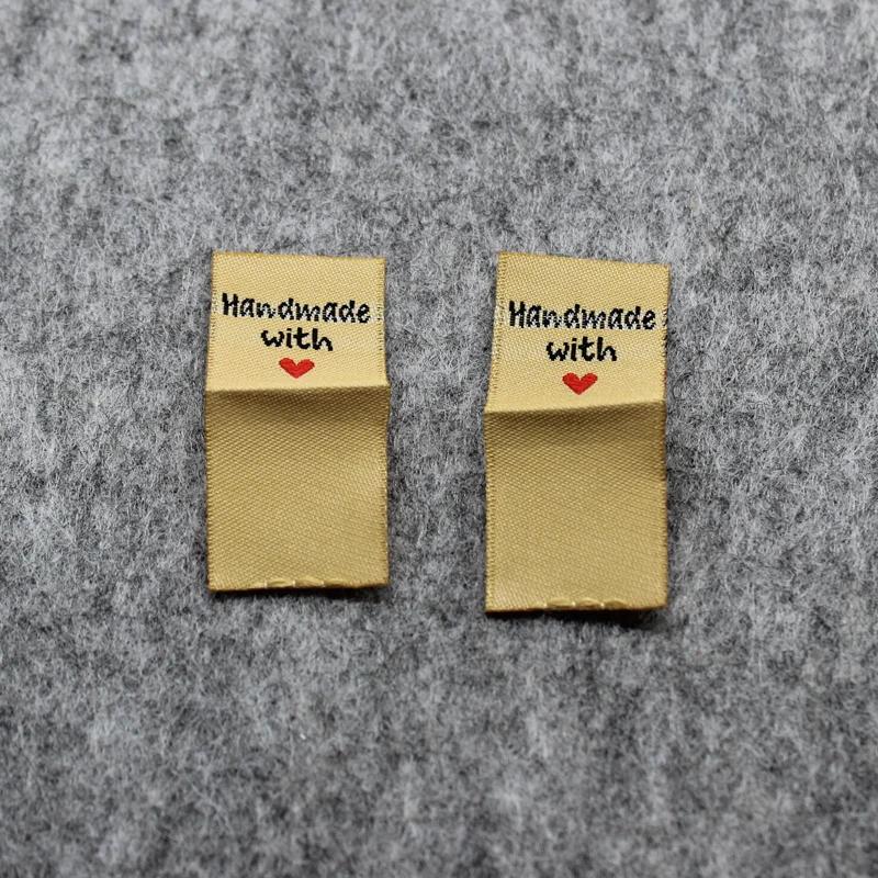 100 peças etiquetas artesanais em estoque/etiquetas douradas/etiquetas personalizadas de tecido/etiquetas bordadas de vestuário - Image 1