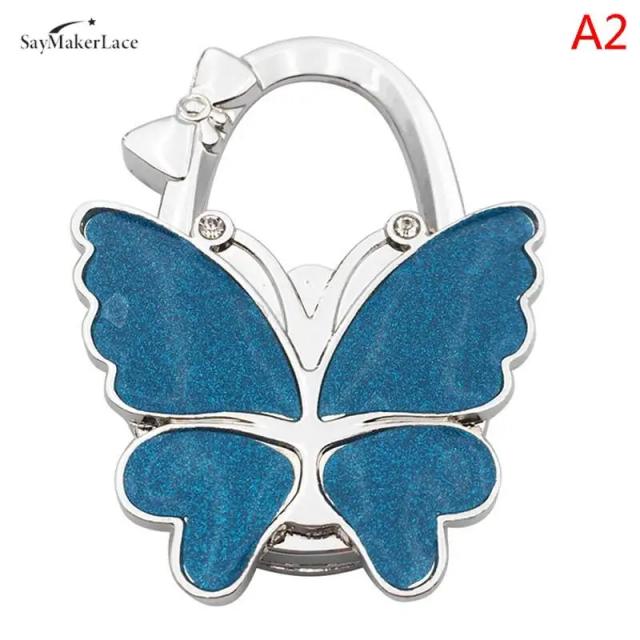 Gancho Dobrável Borboleta para Bolsas Femininas - Suporte de Mesa Portátil e Organizador Decorativo, 1 Unidade