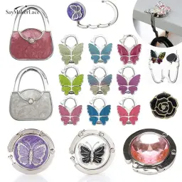 Gancho dobrável de bolsa borboleta para mulheres, cabide de mesa portátil, suporte de bolsa, decoração do organizador, 1pc - Image 1